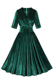 Vestido de terciopelo verde oscuro con volantes y cuello en V de la década de 1950