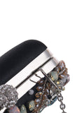 Delicado bolso de mano negro con pedrería