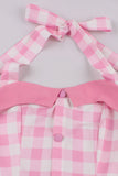 Un vestido rosa a cuadros rosa a cuadros de la década de 1950 con cuello halter