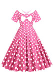 Cuello de barco de lunares rosa Vestido de la década de 1950 con moño