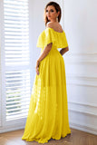 Vestido formal largo amarillo con volantes y aberturas en línea A