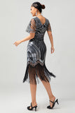 Vestido flapper ajustado de lentejuelas doradas negras de los años 20 con borlas