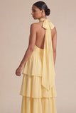 Vestido largo de invitado de boda con lazos con volantes amarillos y lazo.