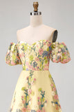 Vestido de invitad con alto y bajo con bordado floral amarillo y mangas abullonadas
