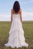 Vestido de novia bohemio con volantes y línea sin tirantes de marfil