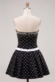 Vestido corto de bienvenida a casa, con moño y lazos con lunares blancos y puntas negras