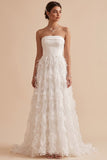 Vestido largo de novia blanco sin tirantes con plumas