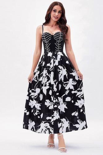 Vestido de fiesta con tirantes de espagueti con estampado de flores blancas negras
