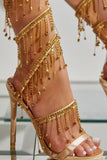 Sandalias doradas de tacón alto con tiras brillantes con borla